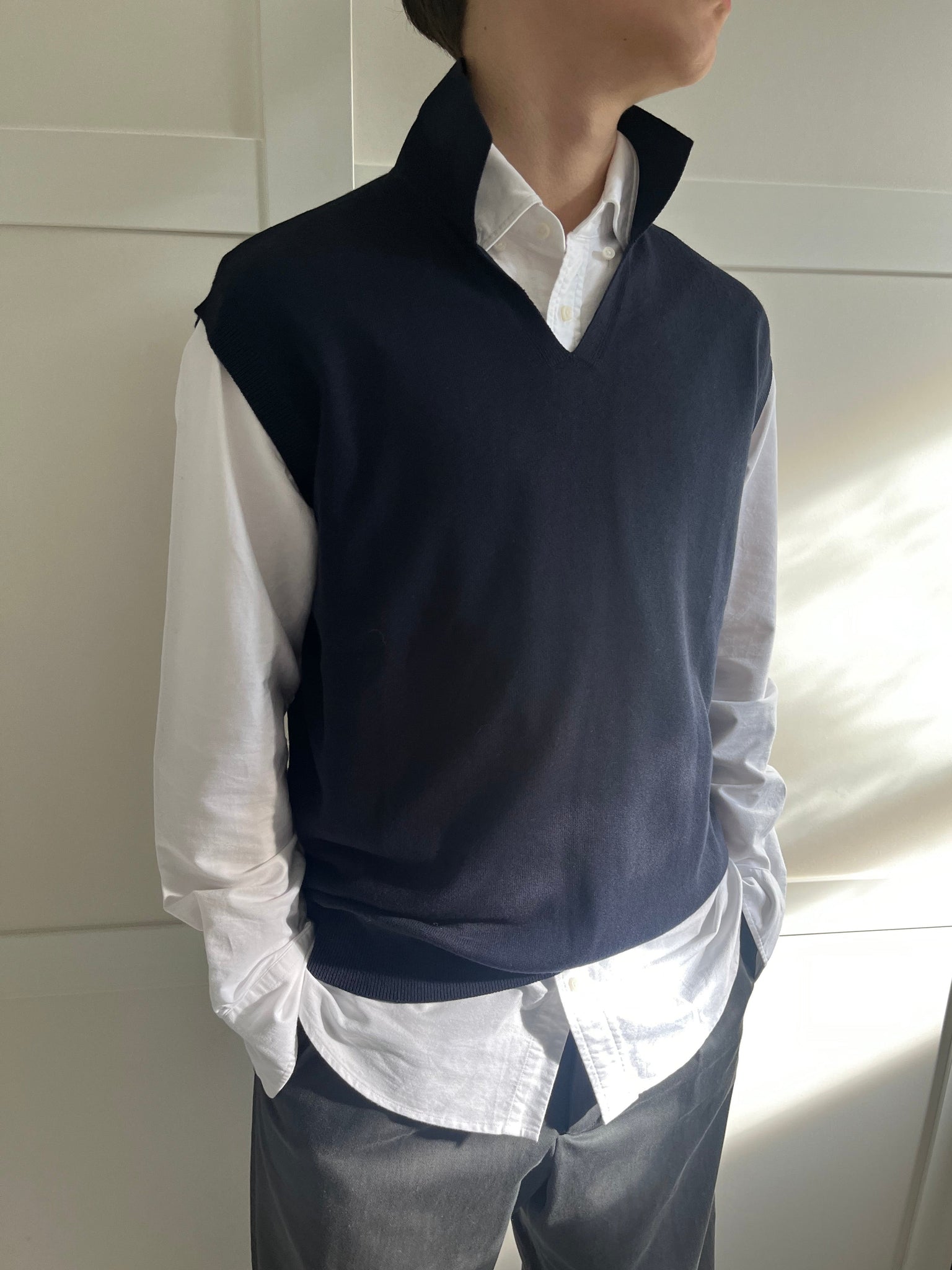Navy knitted tank layered over a white shirt