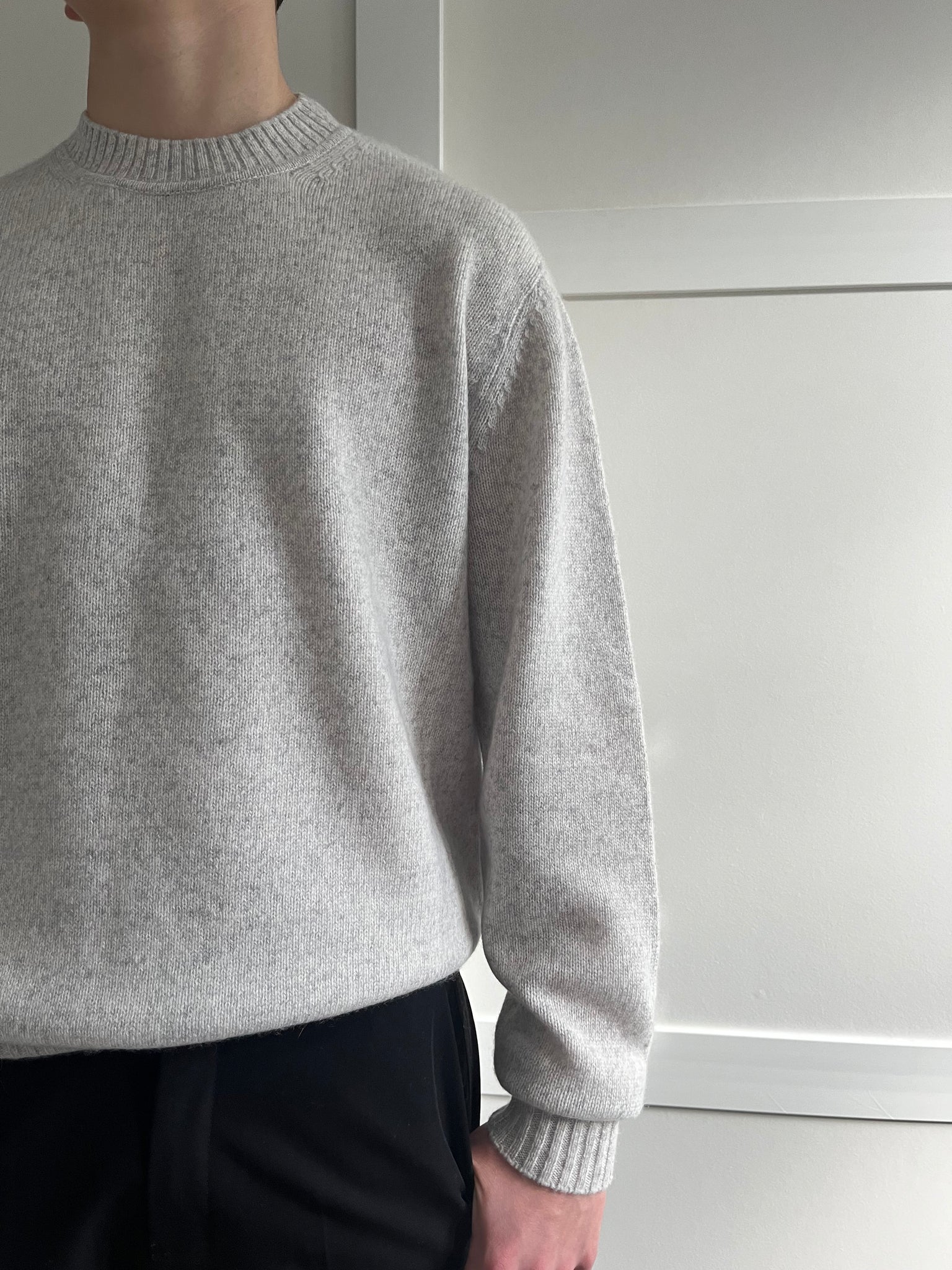 Unisex grey marl cashmere sweater with a white background