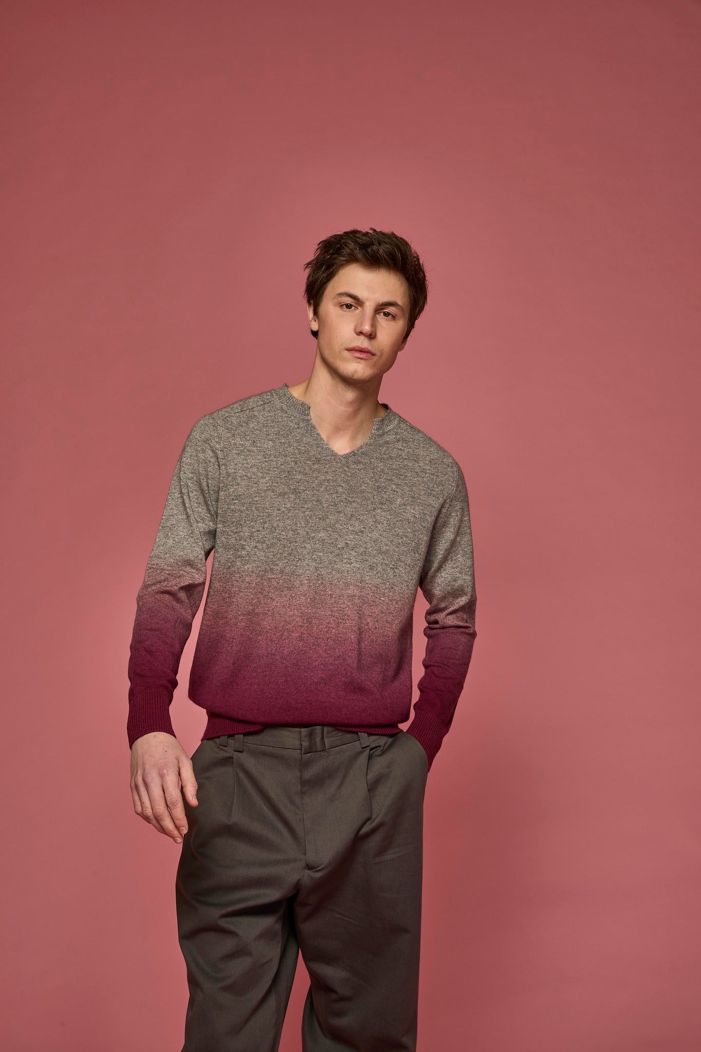 Man wearing a dip-dye sweater in grey and pink